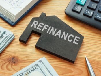 Refinance home mortgage concept. Model of house on the table.